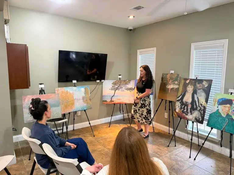 DOCENT interactive art presentation in action — life-size replicas on easels with an engaged audience